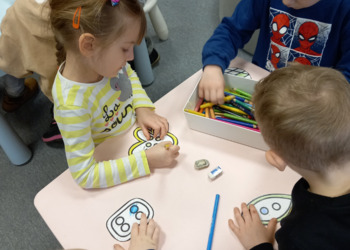 dzieci rysują przy stoliku